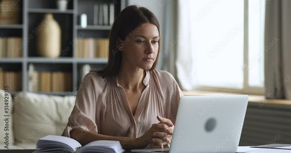 Angry frustrated young woman mad about stuck laptop computer