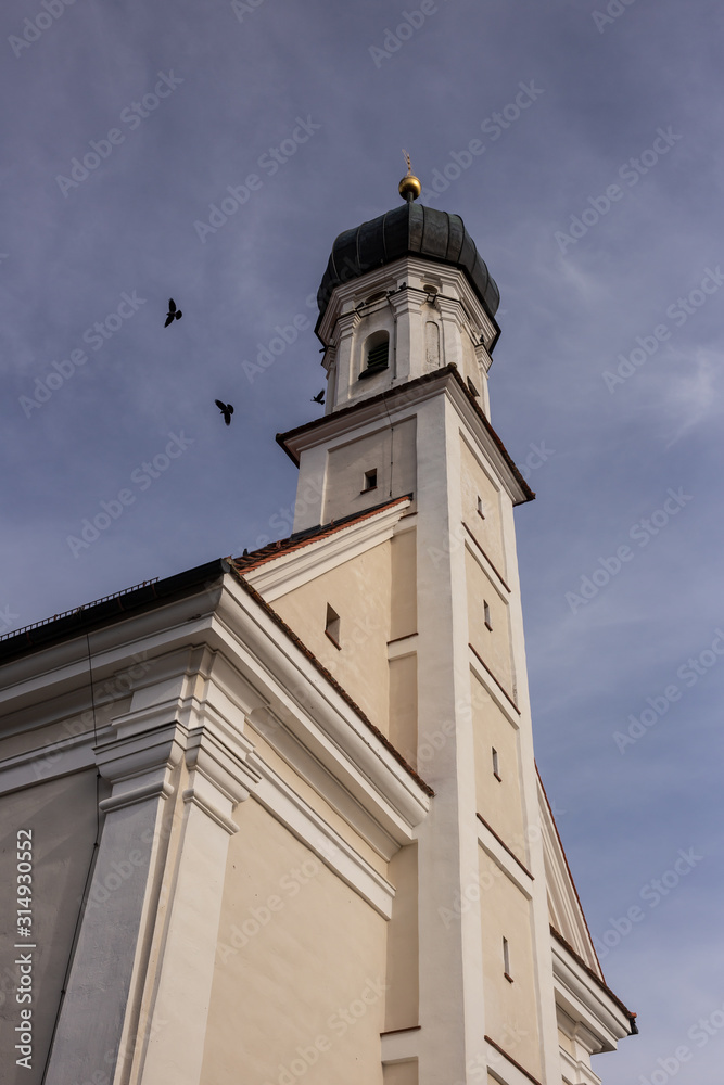 Bird circling the tower of St. Leonhard church in Utting am Ammersee in Upper Bavaria, Germany
