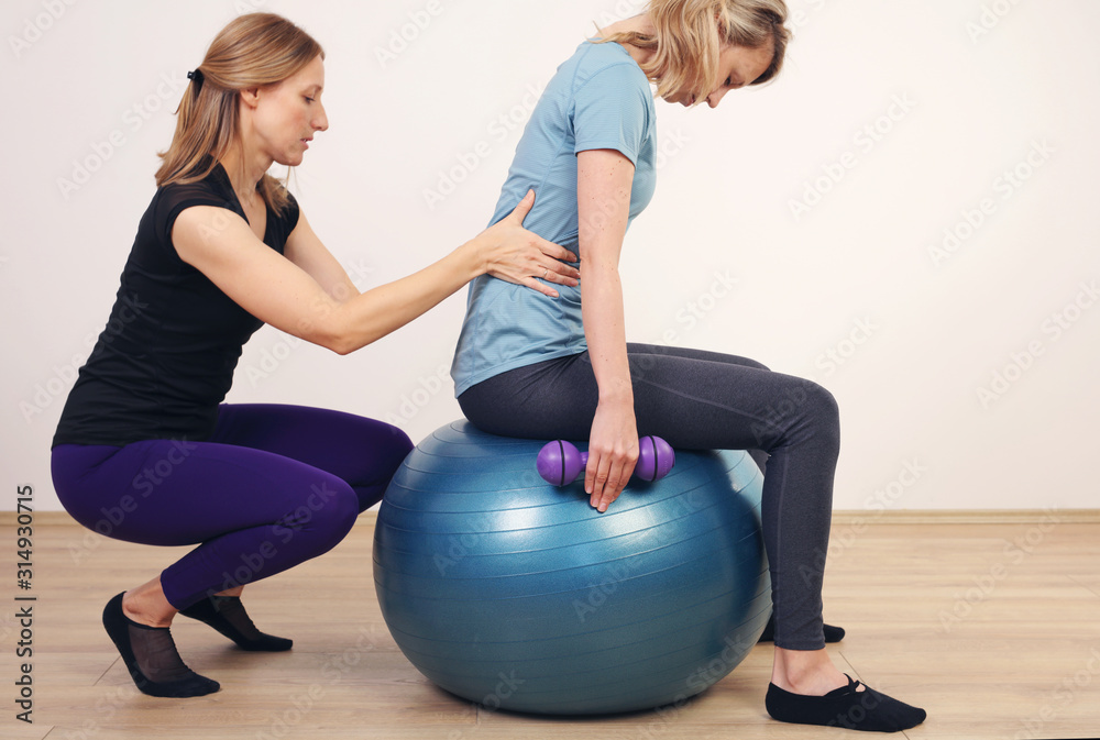 Scoliosis, bad posture correction, Physiotherapy, Kinesiology. Pilates  workout with personal trainer. Photos | Adobe Stock