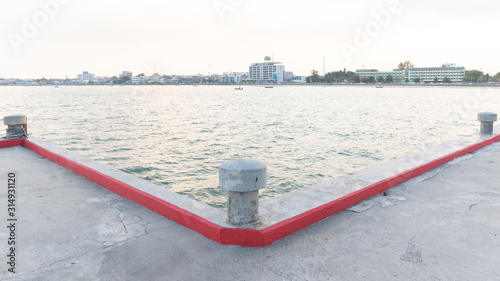 Concrete poles on the bridge at sea With the background is a city, Panorama view