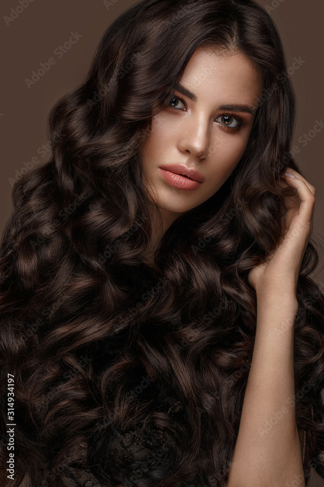 Beautiful brunette model: curls, classic makeup and full lips. The beauty face. Beautiful brunette model: curls, classic makeup and full lips. The beauty face.