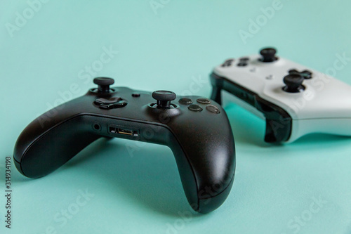 White and black two joystick gamepad  game console isolated on pastel blue colourful trendy background. Computer gaming competition videogame control confrontation concept. Cyberspace symbol.