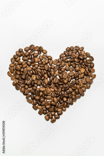  Heart laid out from coffee beans on a white background