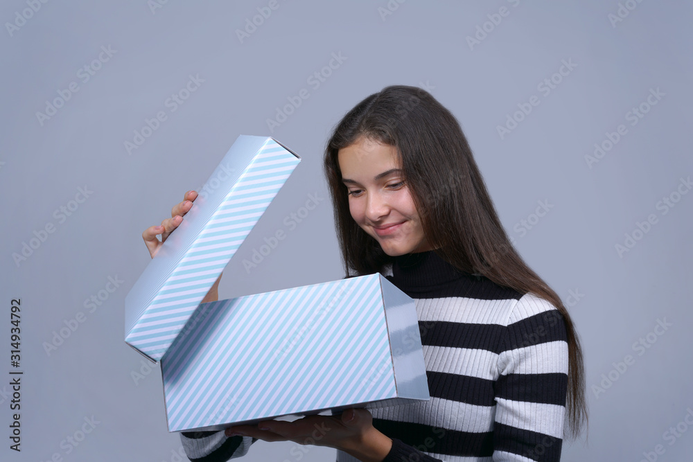 Obraz premium girl with smile opening lid of present box