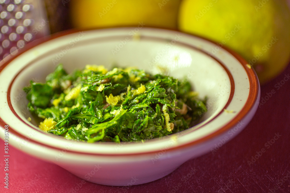 A view of a bowl of gremolata in a lifestyle kitchen setting. A view of a bowl of gremolata in a lifestyle kitchen setting.
