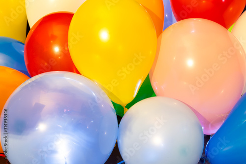 Colorful balloons illuminated with LED against dark background