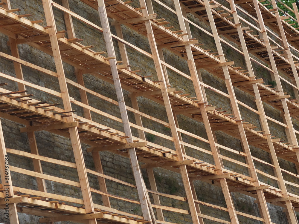 Wooden scaffolding  reconstruction limestone wall