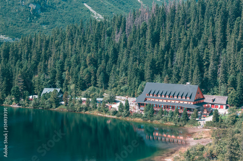 Large wooden hotel on the lake in the mountains