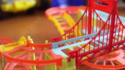 Wallpaper Mural the child plays the game track, the car drives on toy slides along the highway. hands of the baby close-up. Torontodigital.ca