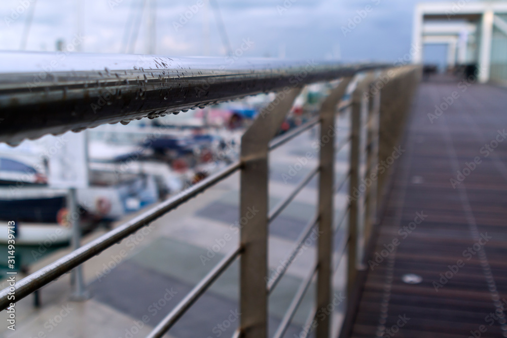 Raindrops on bridge fence 