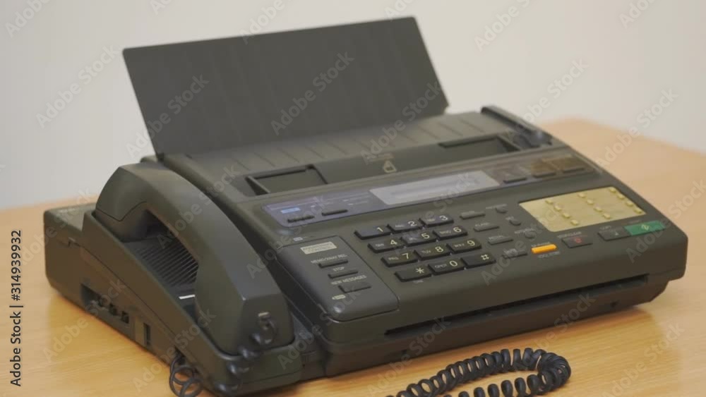 Old office fax machine on the table. Rotation