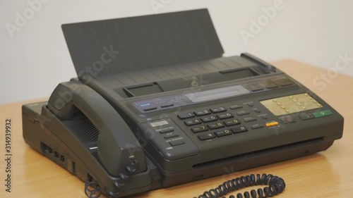 Old office fax machine on the table. Rotation