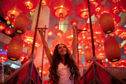 Photography Happy tourist woman enjoying traditional red lanterns decorated for Chinese new year Chunjie