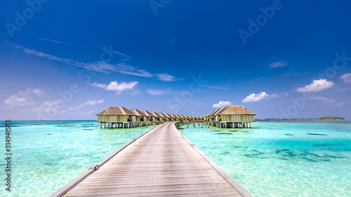 Fototapeta Naklejka Na Ścianę i Meble -  Fantastic landscape of Maldives beach. Tropical panorama, luxury water villa resort with wooden pier or jetty. Luxury travel destination background for summer holiday and vacation concept.