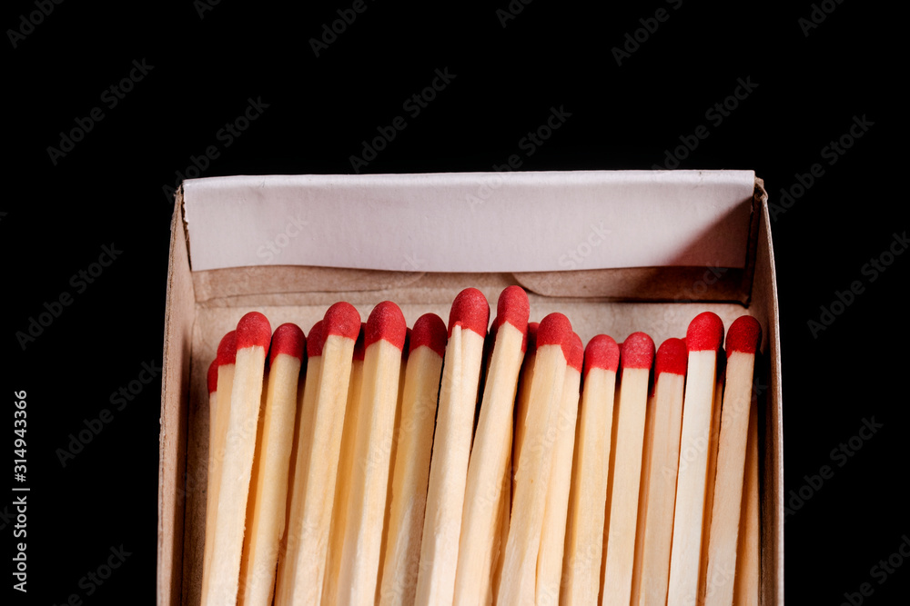 box of matches with matches on a black background