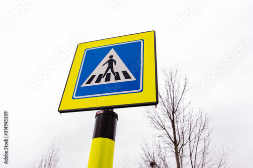 Pedestrian crossing traffic sign in neon yellow and blue colors in the Netherlands
