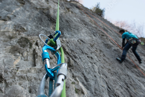 Canvas Print Abseiling with double rope from a mountain wall, close up on the safety equipmen