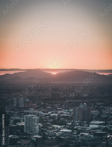 vistas de la ciudad con vistas a la puesta de sol detr  s de las monta  as