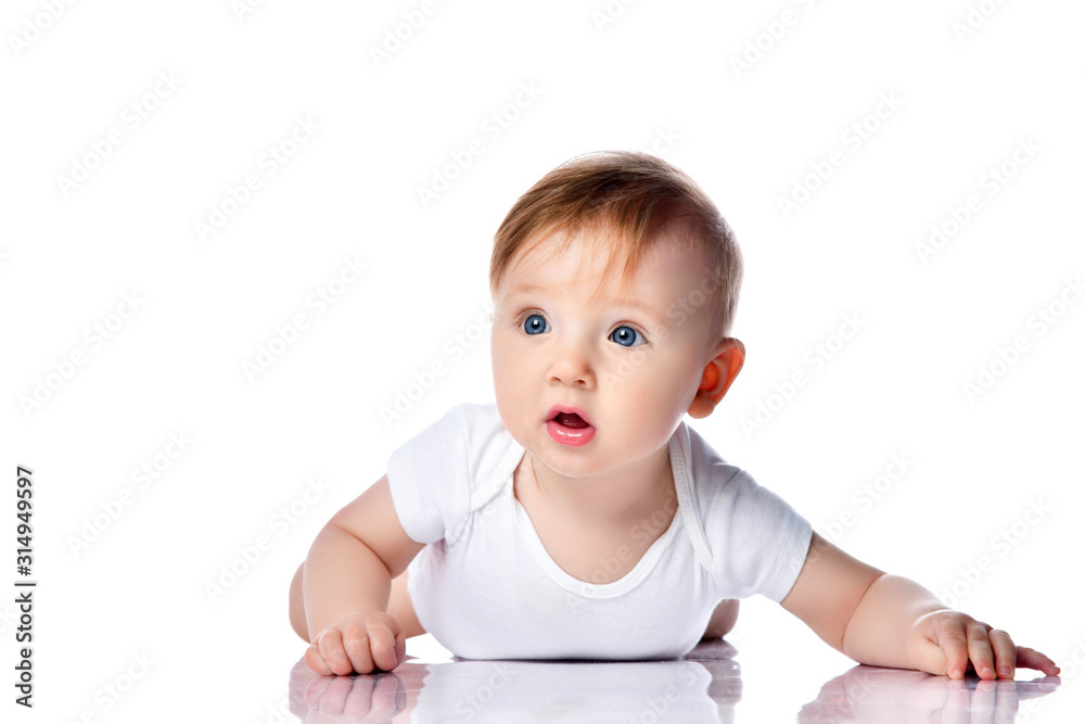Infant child baby boy kid with blue eyes happy smiling screaming lying on a floor isolated on a white background Infant child baby boy kid with blue eyes happy smiling screaming lying on a floor isolated on a white background