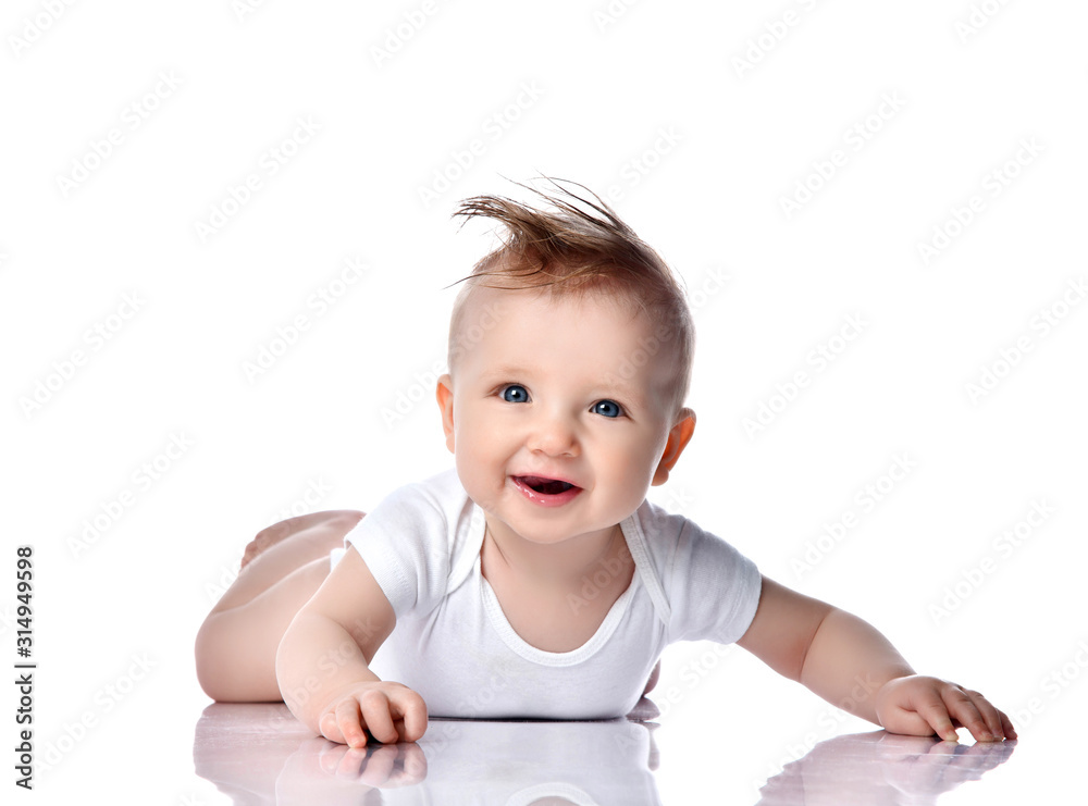 Infant child baby boy kid with blue eyes happy smiling screaming lying on a floor isolated on a white background Infant child baby boy kid with blue eyes happy smiling screaming lying on a floor isolated on a white background