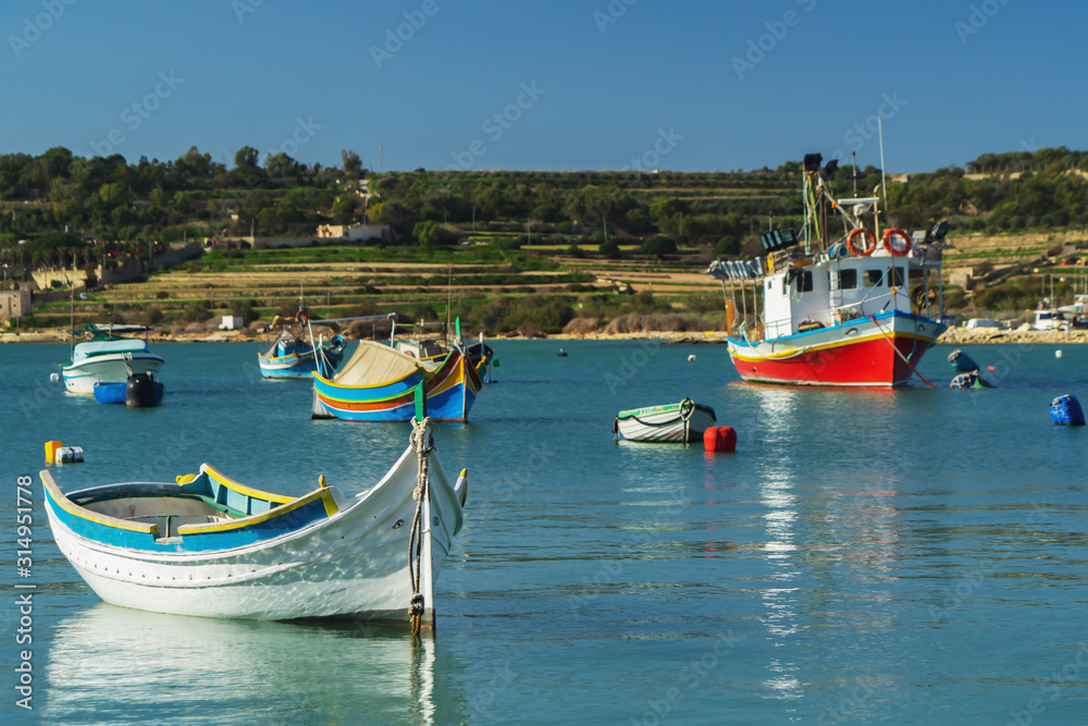 A luzzu is a traditional fishing boat from the Maltese islands. Painted in bright colours, luzzus have existed sin A luzzu is a traditional fishing boat from the Maltese islands. Painted in bright colours, luzzus have existed sin