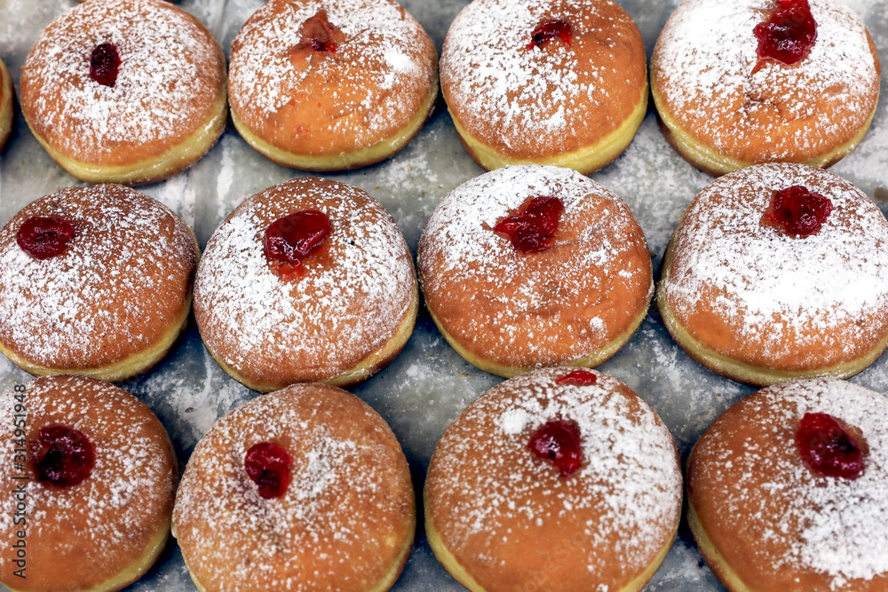 Fresh Hanukkah donuts with jam. Traditional Israeli donuts. Fresh Hanukkah donuts with jam. Traditional Israeli donuts.