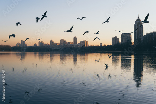 Sunset view of Obolon embankment over Dnipro river in Kyiv, Ukraine photo