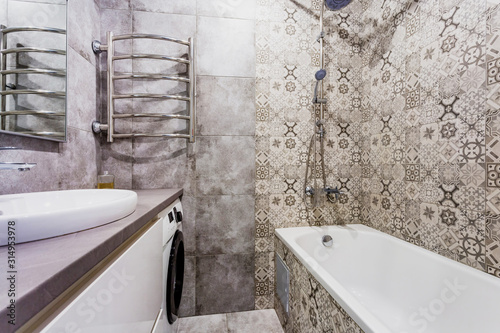 water tap sink with faucet in expensive loft bathroom. detail of a corner shower cabin with wall mount shower attachment