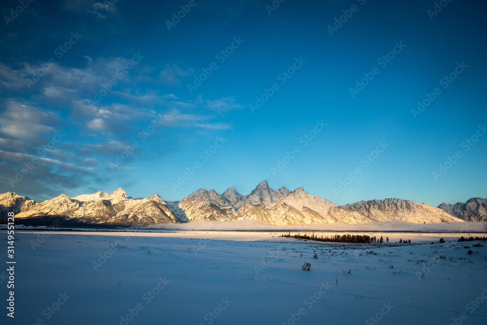 Sunrise over the mountains during winter in Grand Teton National Park. 