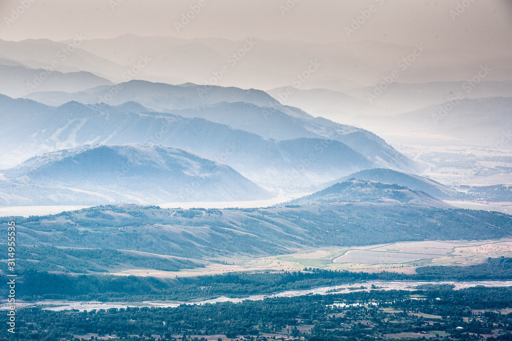 Smoke from a wildfire sits over the mountains in Jackson Hole, Wyoming. Smoke from a wildfire sits over the mountains in Jackson Hole, Wyoming.