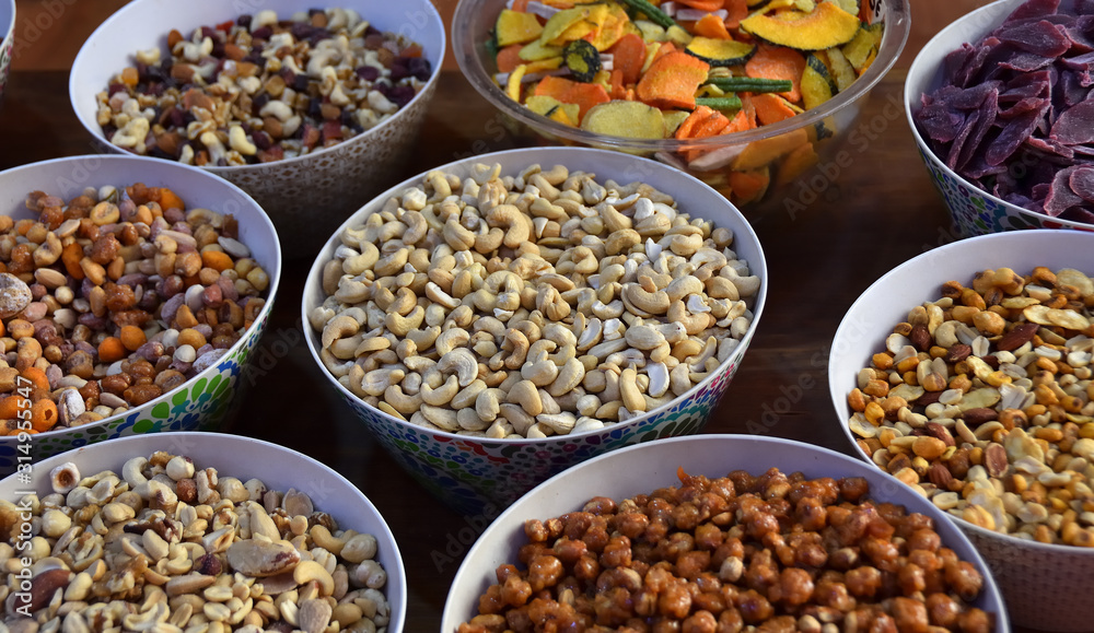 Cashews and other nuts in pretty decorated bowls