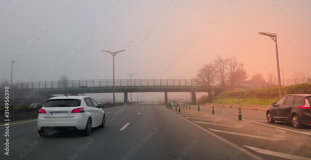 Driving car on highway in fog weather, interior driver view