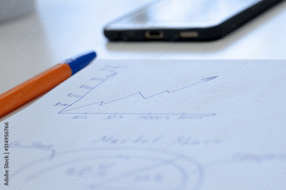 Businessman notes with blue pen. calculations for increasing the profit of your organization and optimizing production. Businessman notes with blue pen. calculations for increasing the profit of your organization and optimizing production.