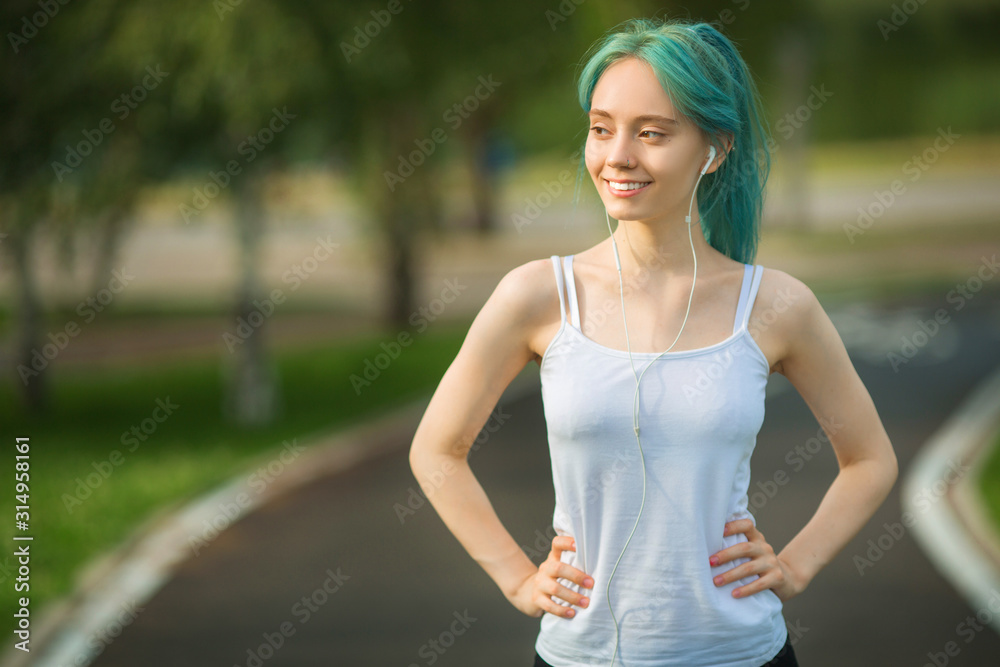 beautiful young woman with a slim figure is jogging in the summer in the park beautiful young woman with a slim figure is jogging in the summer in the park