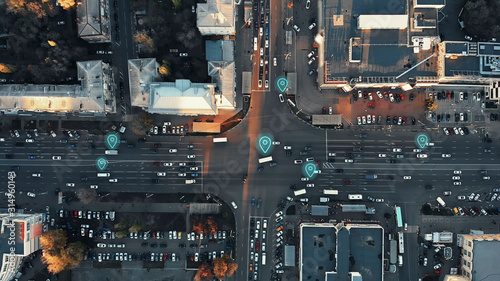 Aerial view of city intersection with many cars and GPS navigation system symbols. Autonomous driverless vehicles in city traffic. Future transportation concept. photo