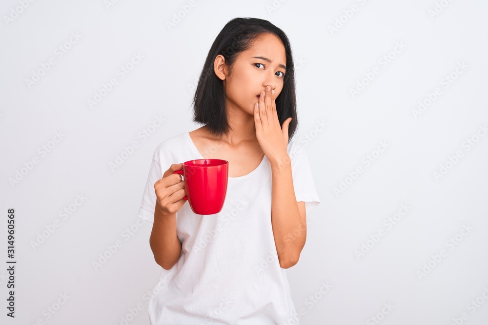 Young beautiful chinese woman drinking cup of coffee over isolated white background cover mouth with hand shocked with shame for mistake, expression of fear, scared in silence, secret concept Young beautiful chinese woman drinking cup of coffee over isolated white background cover mouth with hand shocked with shame for mistake, expression of fear, scared in silence, secret concept