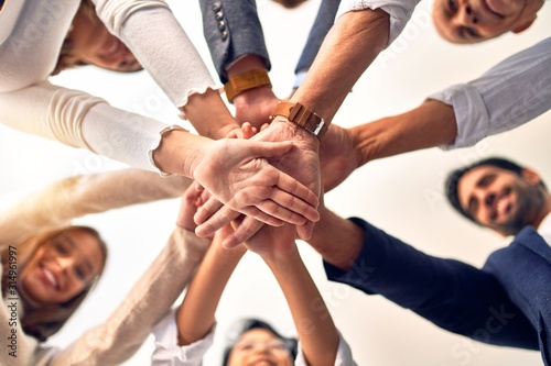 Group of business workers standing with hands together at the office