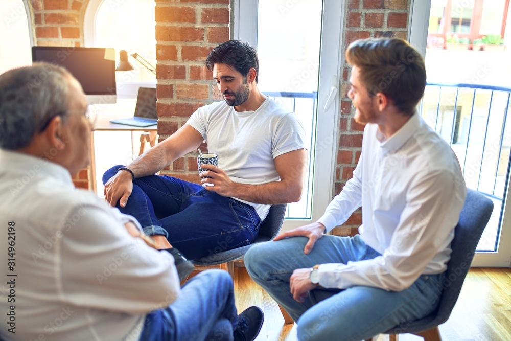 Fototapeta premium Handsome businessmen smiling happy. Sitting with smile on face speaking taking rest at the office