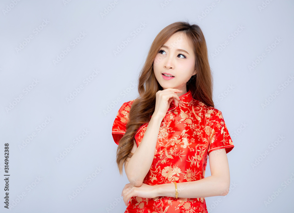 Beautiful portrait happy Chinese New Year young asian woman wear cheongsam fashion think idea isolated on white background, beauty asia girl wish success, festival and celebrate concept. Beautiful portrait happy Chinese New Year young asian woman wear cheongsam fashion think idea isolated on white background, beauty asia girl wish success, festival and celebrate concept.