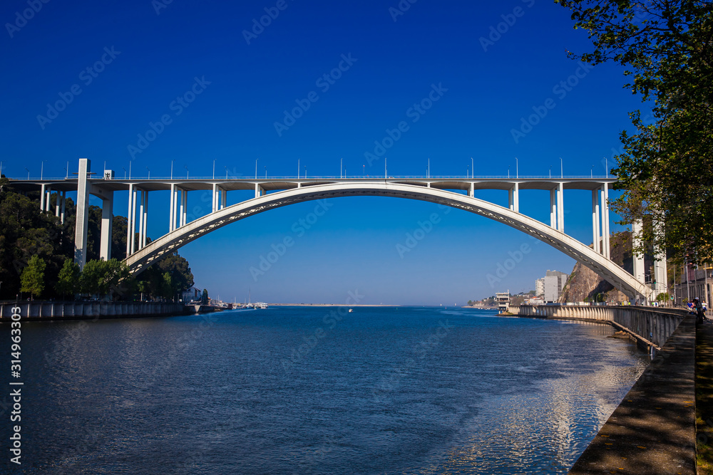 View of the Douro River mouth and the Arrabida Bridge in a beautiful early spring day at Porto City in Portugal View of the Douro River mouth and the Arrabida Bridge in a beautiful early spring day at Porto City in Portugal