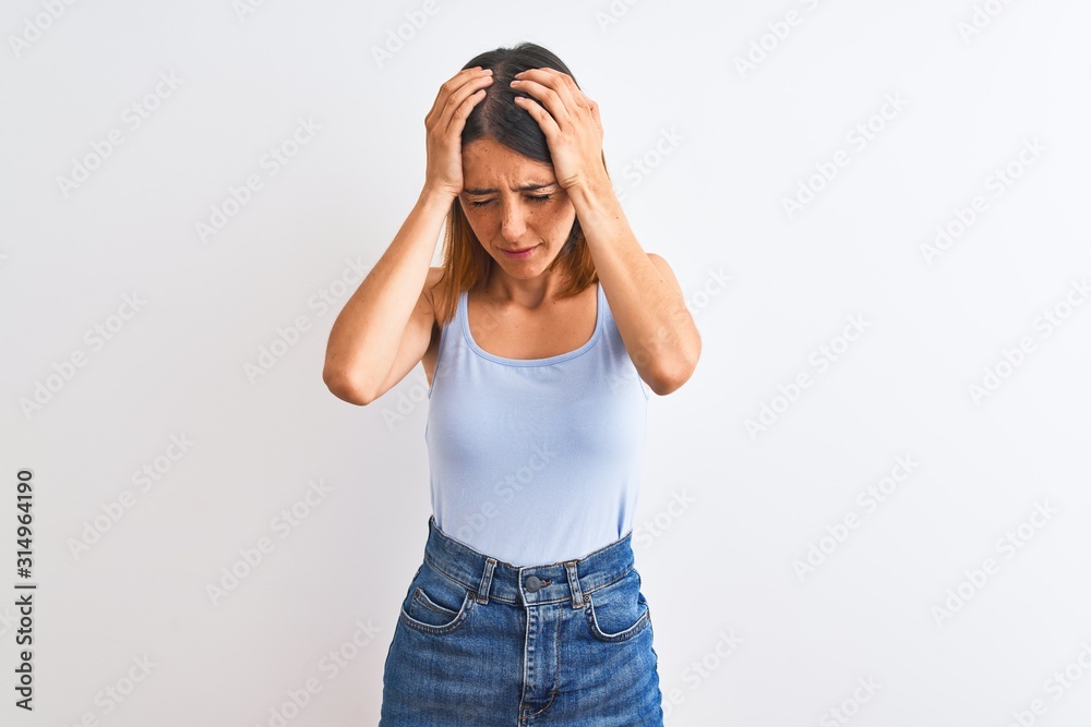 Beautiful redhead woman standing over isolated background suffering from headache desperate and stressed because pain and migraine. Hands on head. Beautiful redhead woman standing over isolated background suffering from headache desperate and stressed because pain and migraine. Hands on head.