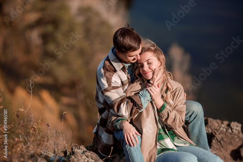 Romantic Couple Sitting And Hugging In Beautiful Mountain Landscape