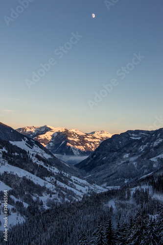 Snowy mountains sunset landscape mountainscape moonrise moon valley view © Andreas