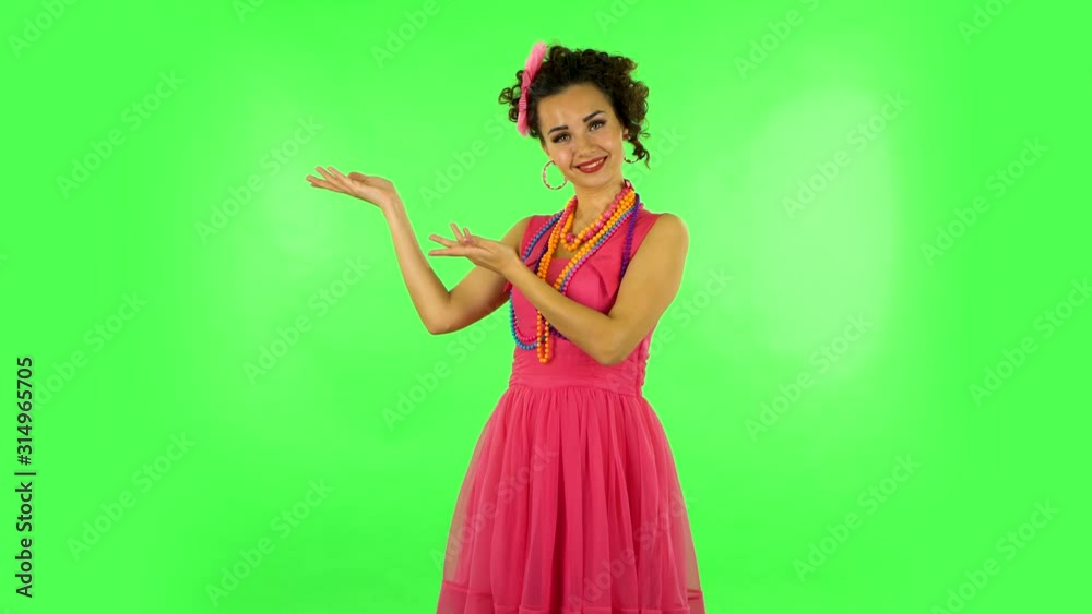 Woman pointing side hand for something and shows thumb like then nods disapprovingly. Green screen Woman pointing side hand for something and shows thumb like then nods disapprovingly. Green screen