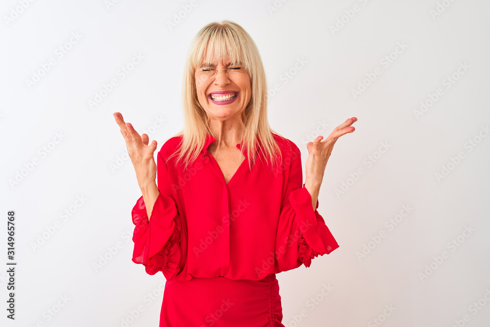 Middle age businesswoman wearing elegant shirt standing over isolated white background celebrating mad and crazy for success with arms raised and closed eyes screaming excited. Winner concept Middle age businesswoman wearing elegant shirt standing over isolated white background celebrating mad and crazy for success with arms raised and closed eyes screaming excited. Winner concept