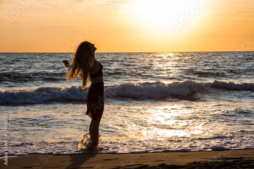Lonely Dancer ballet posing on the beach sunset silhouette sea