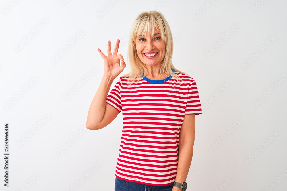 Middle age woman wearing casual striped t-shirt standing over isolated white background smiling positive doing ok sign with hand and fingers. Successful expression. Middle age woman wearing casual striped t-shirt standing over isolated white background smiling positive doing ok sign with hand and fingers. Successful expression.