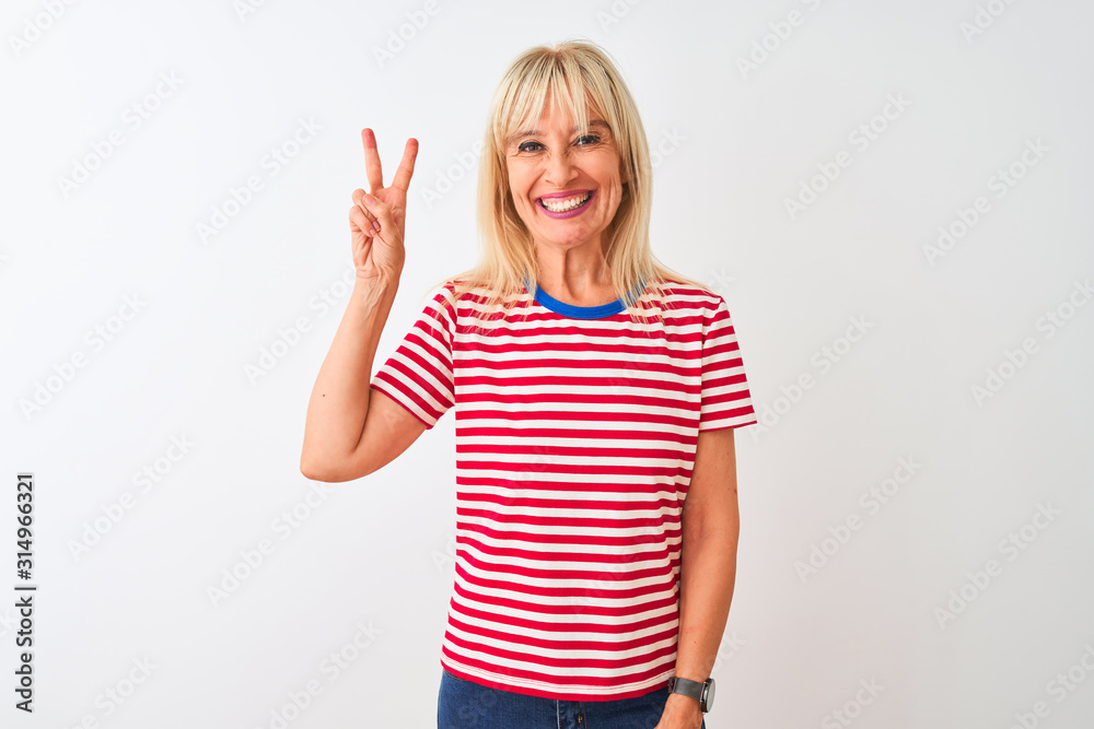 Middle age woman wearing casual striped t-shirt standing over isolated white background showing and pointing up with fingers number two while smiling confident and happy. Middle age woman wearing casual striped t-shirt standing over isolated white background showing and pointing up with fingers number two while smiling confident and happy.
