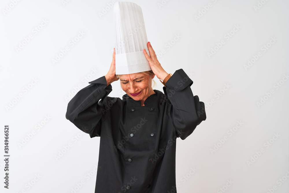 Middle age chef woman wearing uniform and hat standing over isolated white background suffering from headache desperate and stressed because pain and migraine. Hands on head. Middle age chef woman wearing uniform and hat standing over isolated white background suffering from headache desperate and stressed because pain and migraine. Hands on head.