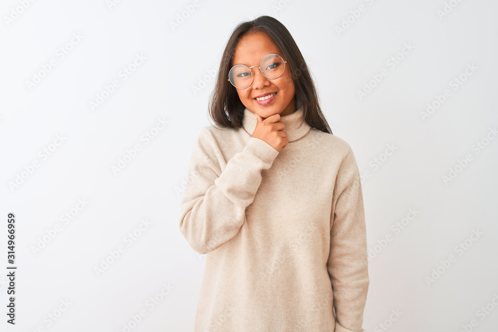 Young chinese woman wearing turtleneck sweater and glasses over isolated white background looking confident at the camera smiling with crossed arms and hand raised on chin. Thinking positive. Young chinese woman wearing turtleneck sweater and glasses over isolated white background looking confident at the camera smiling with crossed arms and hand raised on chin. Thinking positive.